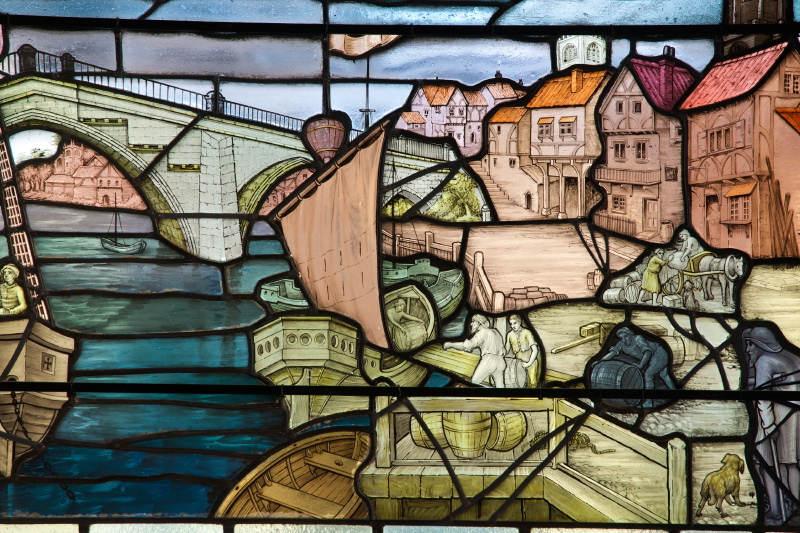 A stained glass panel showing Old Ouse Bridge and a sail boat.